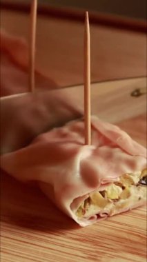 Lezzetli aperatifler yapmak için krem peynirle doldurulmuş mortadella salamı.