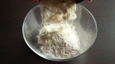 Kuru malzemeyi yakın plan bir kasede pişirmek için karıştırıyorum.