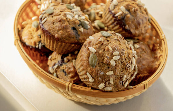  healthy muffins topped with a mix of seeds, perfect for a grab-and-go breakfast