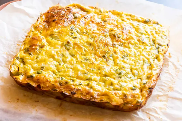 Lezzetli ve sağlıklı süzme peynirli kabaklı kiş. Bu altın fırınlanmış yemek bir kahvaltı ya da hafif bir öğle yemeği için mükemmel.