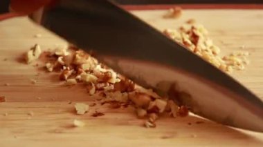 Tahta kesme tahtasına ceviz doğramak stok videosunu kapamak