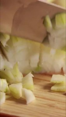 Sarı soğan doğrayan kadın dikey mutfak videosunu kapat