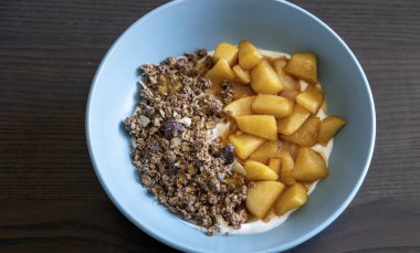 Sıcak sonbahar kahvaltı kasesi Yunan yoğurdu, karamelli elma.