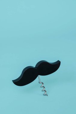 black moustache topping a corkscrew, on a blue background with some blank space on top clipart