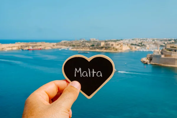 Closeup Man Holding Heart Shaped Black Sign Word Malta Written — Stock Photo, Image