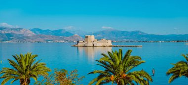 Ege Denizi 'nde, Yunanistan' da Nafplio 'daki Bourtzi şatosunun web pankartı veya başlığı olarak kullanılacak panoramik bir görüntüsü
