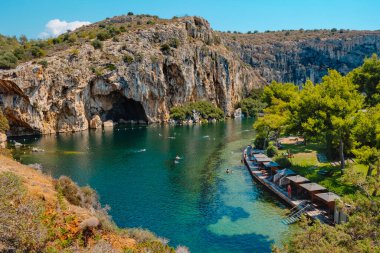 Vouliagmeni, Greece - September 1, 2022: A view over the Lake Vouliagmeni in Vouliagmeni, Greece, in a summer day