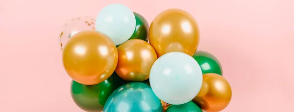 a bunch of balloons of different colors and sizes tied together as a decoration for a birthday party, a baby shower or any other party, in a panoramic format to use as web banner or header