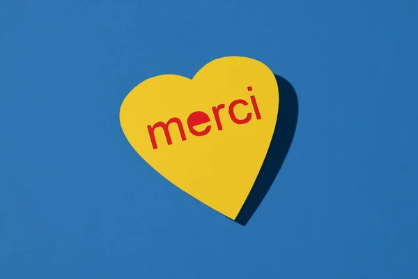 Closeup Yellow Heart Shaped Sign Reads Thank You French Blue — Stockfoto