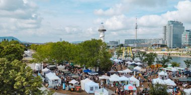 Vienna, Austria - August 28, 2022: A panoramic view of Leuchtturm Wiese, with people taking part in a vegan festival, on Donauinsel Island, an artificial island in the Danube River, in Vienna, Austria