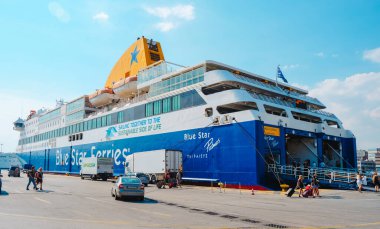 Piraeus, Greece - August 30, 2022: Passengers boarding in a big ferry in the port of Piraeus, Greece, the most important port in the country
