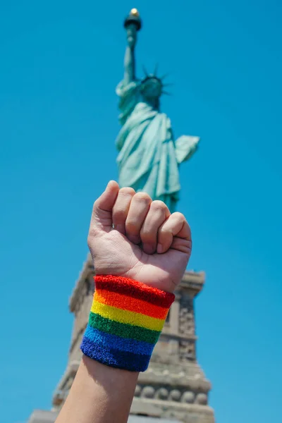 Closeup Man Raising His Fist Wristband Patterned Rainbow Flag Front — Stock Photo, Image