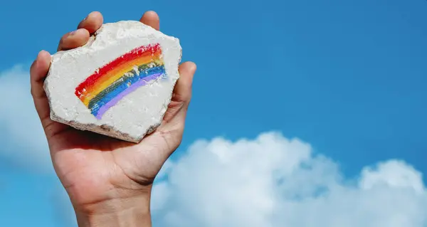 Hand Man Holding Rock Rainbow Flag Painted Sky Sunny Day — Stock Photo, Image