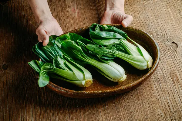 Closeup Man Casserole Some Bok Choys His Hands Leaning Rustic Stock Image