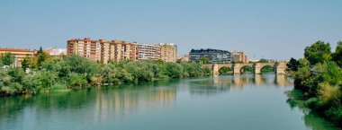 İspanya 'daki Zaragoza' dan geçerken Ebro Nehri 'nin manzarası, ya da İspanya' daki Taş Köprüsü, ya da arka planda Puente de Piedra, web pankartı olarak kullanılacak şekilde panoramik bir formatta.