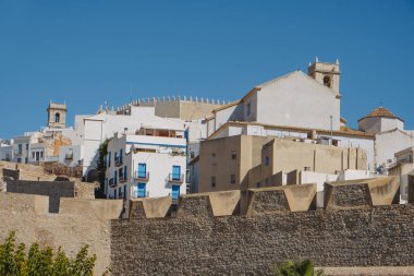 a view of the old walled town of Peniscola, in Spain, highlighting its thick fortified walls in the foreground