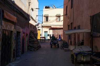 MARRAKECH, MOROCCO - DECEMBER 23, 2022: People walking in street of Marrakesh, Morocco. 