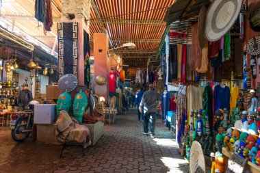 MARRAKECH, MOROCCO - DECEMBER 20, 2022: People walking in famous Marrakesh souk in Marrakesh, Morocco. 