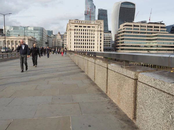 stock image LONDON, UK - CIRCA OCTOBER 2022: People crossing London Bridge over River Thames