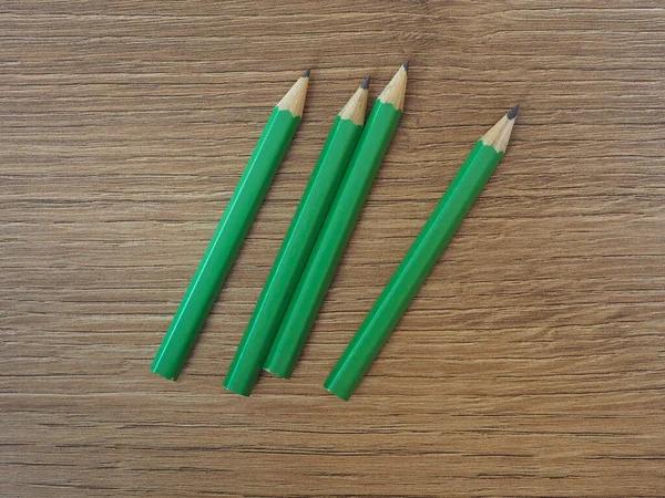 Four Green Pencils Wooden Table Desktop — Stock Photo, Image