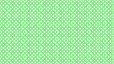 white polka dots pattern over light green useful as a background
