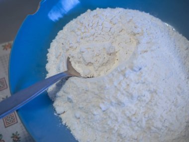 flour in a dish with a spoon