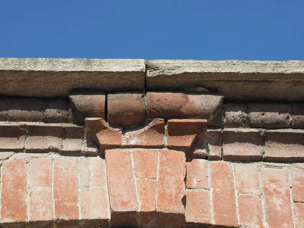ancient brick arch keystone over the blue sky
