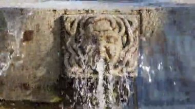 water jet from an ancient stone fountain