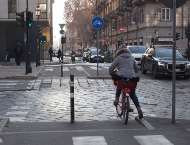 TURIN, ITALY - CIRCA FEBRUARY 2023: Bicycle lane with woman on bike