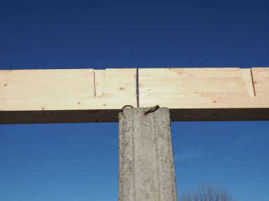 wooden beam on concrete pillar for roof construction works in a building site