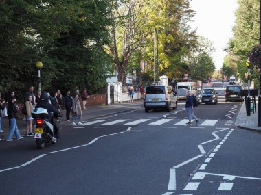 LONDON, UK - CIRCA OCTOBER 2022: People crossing Abbey Road zebra crossing made famous by the 1969 Beatles album cover