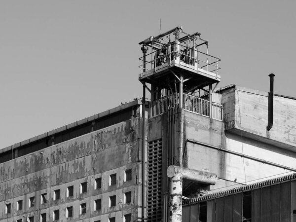 Industrial ruins of an old abandoned factory in black and white