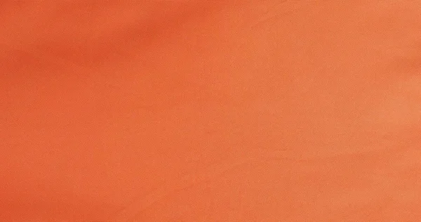 背景として役立つオレンジ色のポリエステル生地の質感 — ストック写真