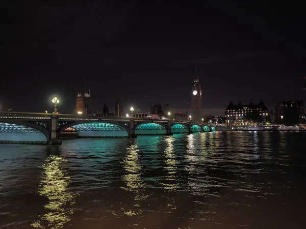 Houses of Parliament and Westminster Bridge at night in London, UK