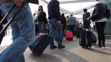 STANSTED, UK - SEPTEMBER 24, 2015: Travellers waiting for tranport at London Stansted airport coach station clipart