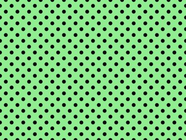 black polka dots pattern over light green useful as a background