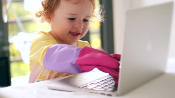 那个戴橡胶手套的小女孩在笔记本电脑上工作 — 图库视频影像