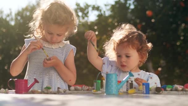 Две Очаровательные Маленькие Девочки Рисуют Камнях — стоковое видео