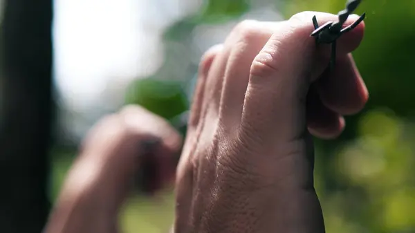 stock image Man touches barbed wire, close-up