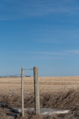 Fence posts with wire around a farm