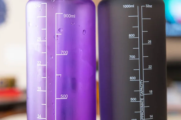 Black Purple Water Bottles Table — Stock Photo, Image