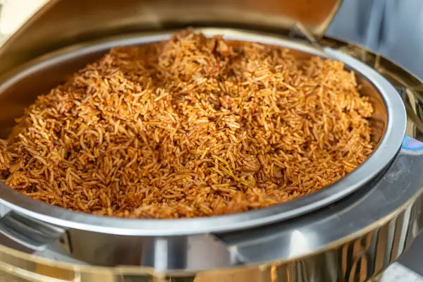 stock image Jollof Rice In Chaffing Dish at a Nigerian celebration