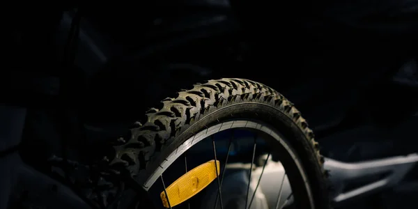 Mountain bike wheel with reflector on black background.