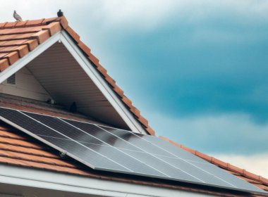 Çatı kiremitli güneş panelleri dramatik gökyüzü arkaplanına sahip.