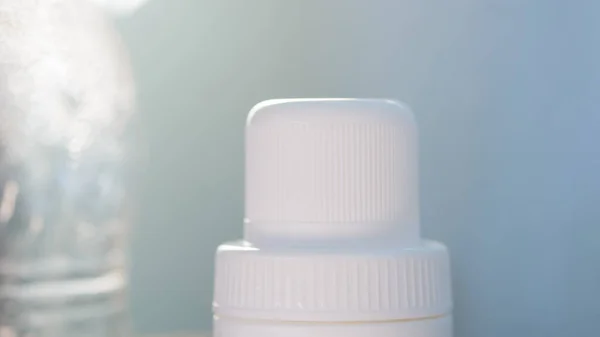White plastic bottle cap on natural light background.