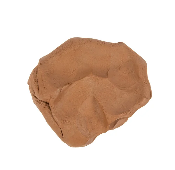 Piedra de arcilla marrón comestible con pequeñas palas de jardín sobre un  fondo blanco.
