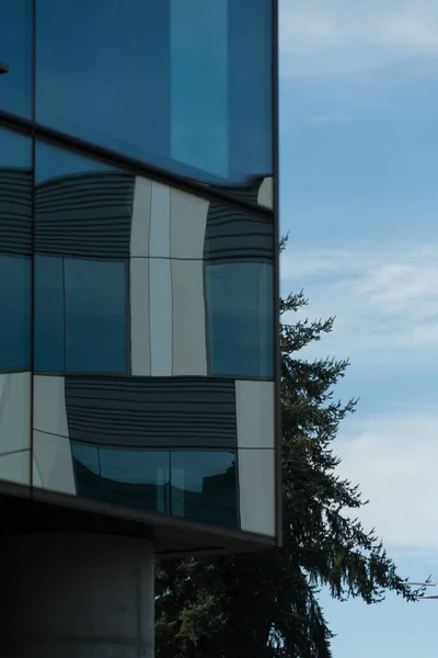 Sharp edged office building with abstract reflections in windows in business campus on Eastside, Redmond, Washington