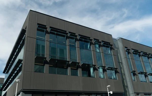 Dark grey cube of office building under blue sky in campus on Eastside, Redmond, Washington