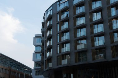 Layers of glass walls in Tjuvholmen under soft dusk lights, Oslo, Norway clipart