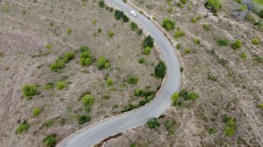 aerial view of car driving on mountain road